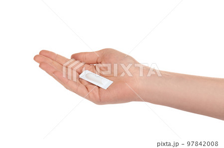Woman holding suppository on white background. Hemorrhoid problems 97842008