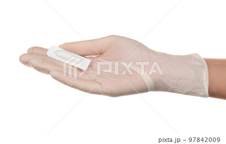Doctor holding suppository on white background. Hemorrhoid problems 97842009