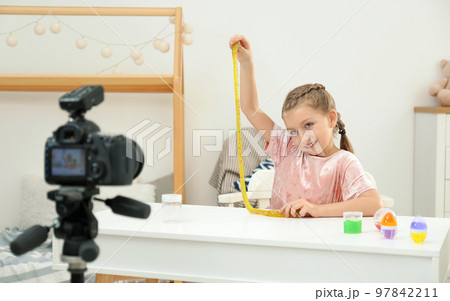Cute little blogger with slime recording video at home Cute little blogger with slime recording video at home 97842211