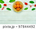 Chinese language mean rich or wealthy and happy.Top view aerial image decoration Chinese new year  lunar new year holiday background concept.Flat lay red orange with blossom on modern  white table. 97844492