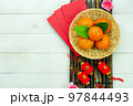 Chinese language mean rich or wealthy and happy.Top view aerial image decoration Chinese new year  lunar new year holiday background concept.Flat lay red orange with blossom on modern  white table. 97844493