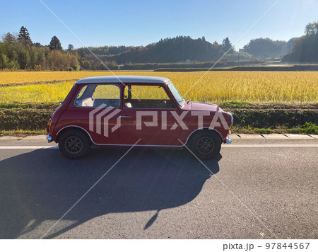 収穫を終えた黄金色の水田前に停めたミニクーパー 収穫を終えた黄金色の水田前に停めたミニクーパー 97844567