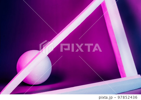 Modern product showcase with dark blue and purple neon light background. Geometrical shapes of ball and triangle made of styrofoam. Selective focus, copy space. Modern product showcase with dark blue and purple neon light background. Geometrical shapes of ball and triangle made of styrofoam. Selective focus, copy space. 97852436