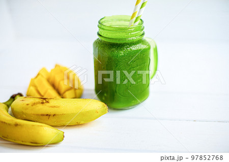 Side view of smoothie with banana, mango, spinach on wooden table. Healthy food. Copy Space  97852768