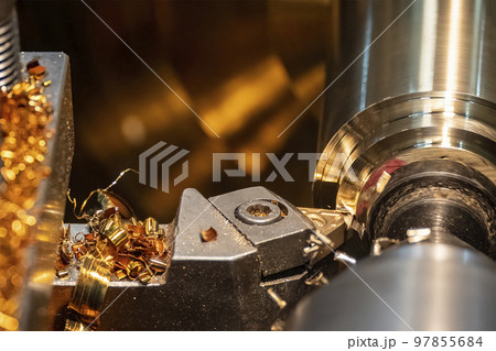 Closeup scene the lathe machine finish cut the brass parts by lathe tools. Closeup scene the lathe machine finish cut the brass parts by lathe tools. 97855684