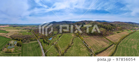 Drone flight over mountain village among green agricultural fields, Countryside view, Nature landscape panorama Drone flight over mountain village among green agricultural fields, Countryside view, Nature landscape panorama 97856054