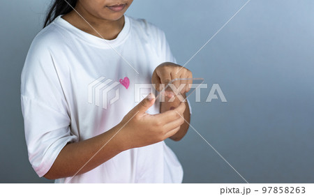woman holding a blank screen phone mockup transparent acrylic used for displaying text or advertising images. 97858263