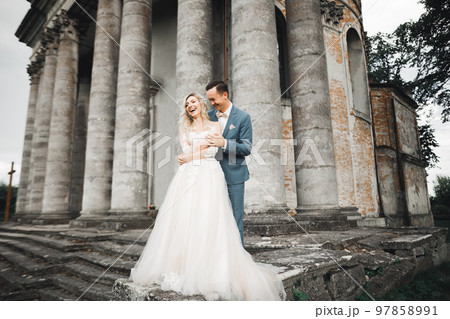 Wedding couple holding hands, groom and bride together on wedding day 97858991