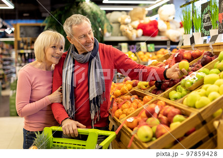 Loving elderly couple making shopping at supermarket Loving elderly couple making shopping at supermarket 97859428