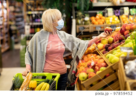 Senior woman in face mask shopping while coronavirus pandemic Senior woman in face mask shopping while coronavirus pandemic 97859452