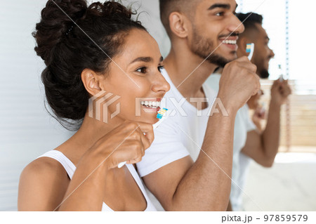 Personal Hygiene. Closeup Shot Of Young Arabic Couple Brushing Teeth Together 97859579