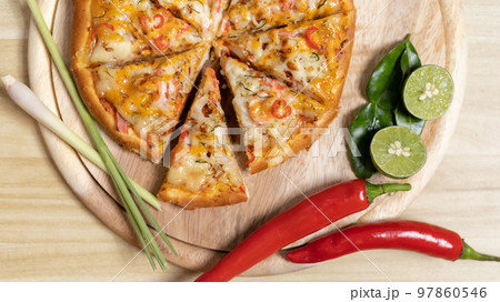 Tom Yum Pizza made by Thailand, Ingredients of Tom Yum Kung are the original curry paste, Lemongrass, Kaffir lime leaves and lime. Promotional poster for restaurant or pizza sale, Text space. 97860546