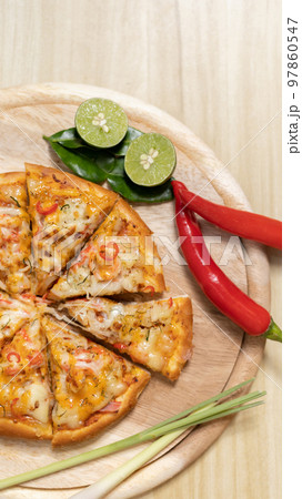 Tom Yum Pizza made by Thailand, Ingredients of Tom Yum Kung are the original curry paste, Lemongrass, Kaffir lime leaves and lime. Promotional poster for restaurant or pizza sale, Text space. 97860547