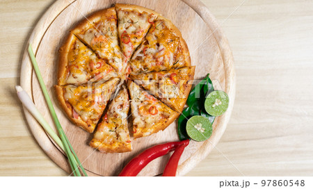 Tom Yum Pizza made by Thailand, Ingredients of Tom Yum Kung are the original curry paste, Lemongrass, Kaffir lime leaves and lime. Promotional poster for restaurant or pizza sale, Text space. 97860548