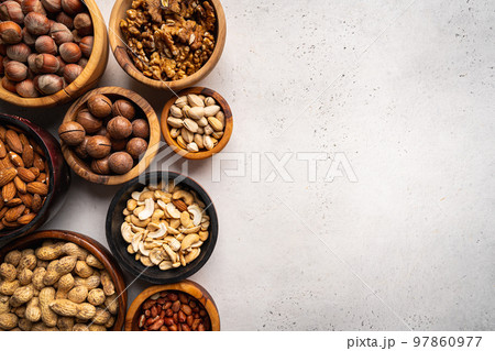 Assortment of nuts in bowls 97860977
