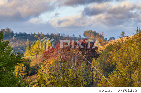 Foggy early morning autumn mountains scene. Peaceful picturesque traveling, seasonal, nature and countryside beauty concept scene. Carpathian Mountains, Ukraine. 97861255