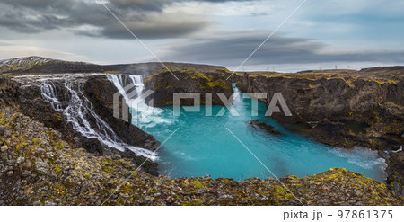Picturesque waterfall Sigoldufoss autumn view. Season changing in southern Highlands of Iceland. 97861375