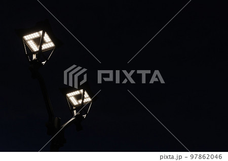 Glowing street lights are under night sky Glowing street lights are under night sky 97862046