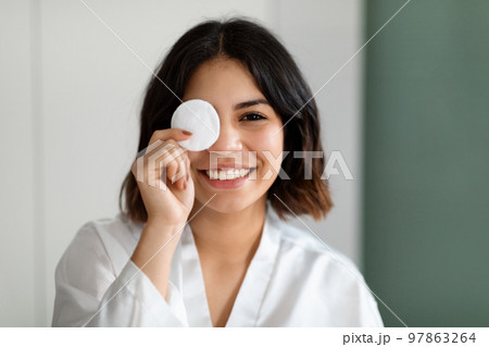 Closeup of arabic woman cover one eye with cotton pad Closeup of arabic woman cover one eye with cotton pad 97863264