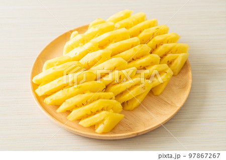 fresh pineapple sliced on plate 97867267