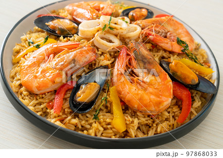 Seafood Paella with prawns, clams, mussels on saffron rice Seafood Paella with prawns, clams, mussels on saffron rice 97868033