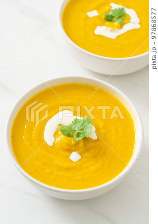 pumpkin soup in white bowl 97868577