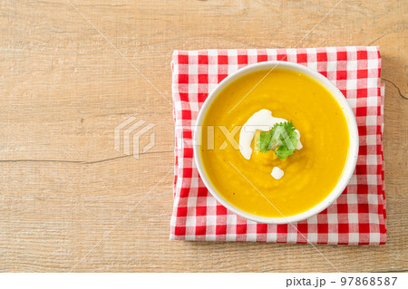 pumpkin soup in white bowl 97868587