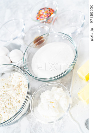 Ingredients in glass mixing bowls to bake funfettti bundt cake. Ingredients in glass mixing bowls to bake funfettti bundt cake. 97869650