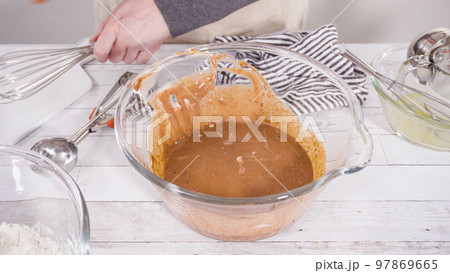 Mixing ingredients to bake chocolate raspberry cupcakes. 97869665