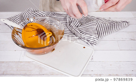 Preparing homemade chocolate ganache for chocolate raspberry cupcakes. Preparing homemade chocolate ganache for chocolate raspberry cupcakes. 97869839