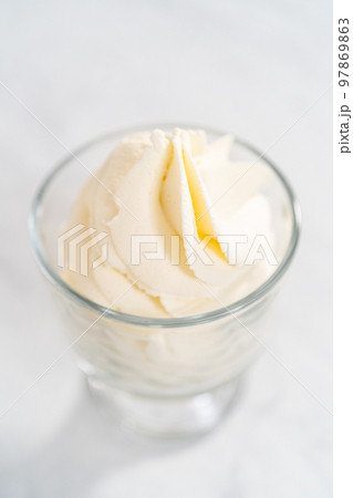 Homemade whipped cream in a class ice cream bowl. 97869863