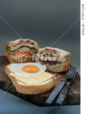 Homemade Sandwichs stuffed Ham, Cheese, Crab stick and vegetables with Cheese and Fried egg on Bread. Homemade Sandwichs stuffed Ham, Cheese, Crab stick and vegetables with Cheese and Fried egg on Bread. 97875108