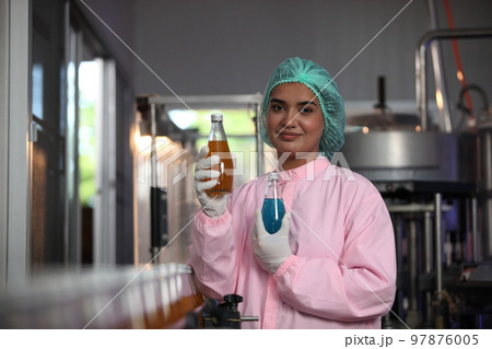 Factory worker inspecting production line of drink production in factory , Concept of food industry 97876005