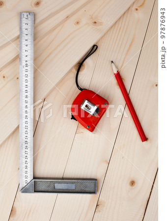 A measuring tape, a square and a pencil. A measuring tape, a square and a pencil. 97876943