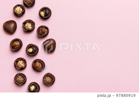 Different kinds of chocolates on colored table close-up. Top View and Flat Lay with copy space Different kinds of chocolates on colored table close-up. Top View and Flat Lay with copy space 97880919