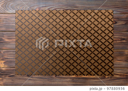 Top view of brown tablecloth for food on wooden background. Empty space for your design Top view of brown tablecloth for food on wooden background. Empty space for your design 97880936