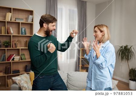 Happy Couple Holding Key. Happy Young Family Holding Key and Rejoicing 97881053