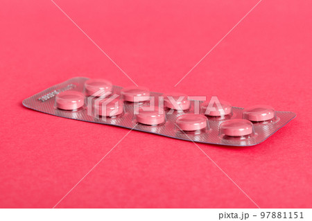 Blister package with Vitamin on color background. Medicine pills on a light background. Medicines and prescription pills flat lay background. pink medical tablets in blister Blister package with Vitamin on color background. Medicine pills on a light background. Medicines and prescription pills flat lay background. pink medical tablets in blister 97881151