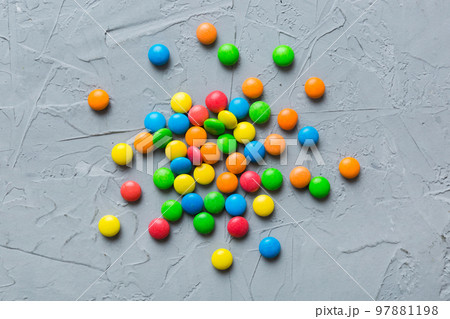 Mixed collection of colorful candy, on colored background. Flat lay, top view. frame of colorful chocolate coated candy Mixed collection of colorful candy, on colored background. Flat lay, top view. frame of colorful chocolate coated candy 97881198