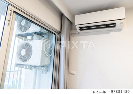 two air conditioning compressors are hung on wall. two air conditioning compressors are hung on wall. 97881480