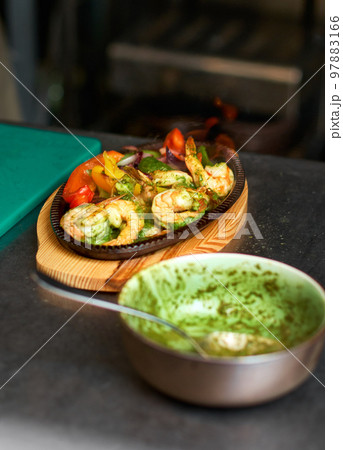 Traditional Mexican beef fajitas on fire in the kitchen, also called alambre Traditional Mexican beef fajitas on fire in the kitchen, also called alambre 97883166