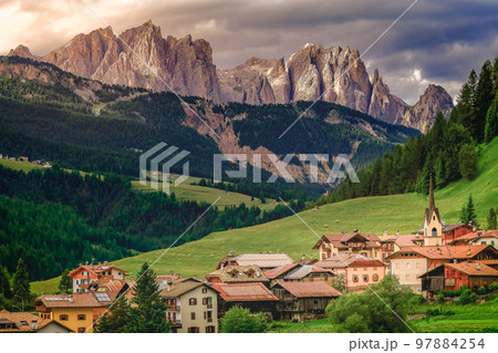 Langkofel and alpine village, Dolomites sudtirol near Cortina d Ampezzo 97884254