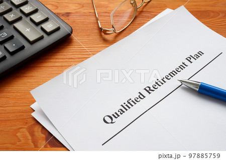 Qualified retirement plan, a calculator and glasses. 97885759