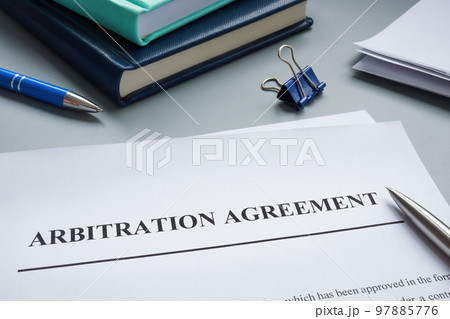 Papers with arbitration agreement and a pen. Papers with arbitration agreement and a pen. 97885776