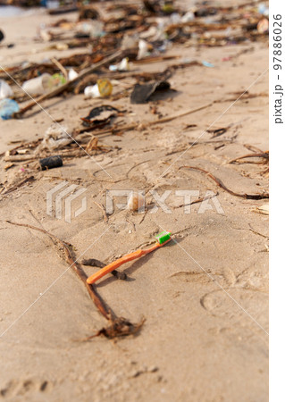 Mountains of waste and garbage on the sandy beach after the tide. Humanity is polluting the ocean Mountains of waste and garbage on the sandy beach after the tide. Humanity is polluting the ocean 97886026