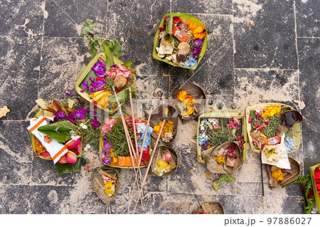 The layout on the ground of traditional offerings for the spirits on the island of Bali The layout on the ground of traditional offerings for the spirits on the island of Bali 97886027