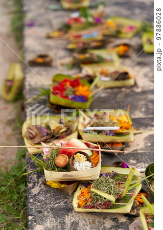 The layout on the ground of traditional offerings for the spirits on the island of Bali The layout on the ground of traditional offerings for the spirits on the island of Bali 97886028