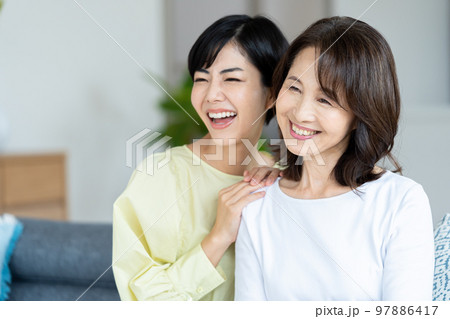 リビングでくつろぐ親子 97886417