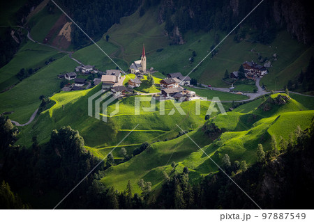 Romantic small village with chapel in the South Tyrolean Alps in Italy 97887549