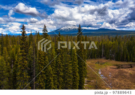 Aerial view of Mt. Bachelor over forests from Lava Lake Road in Oregon, USA 97889643